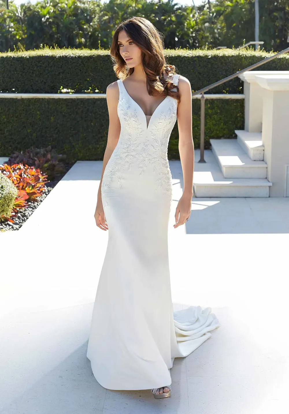 Clean v-neck wedding gown with subtle lace bodice detail and a smooth flowing skirt, part of The Bridal Edit at SNOB in Eccleshall